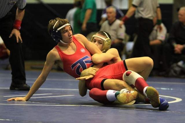 Description: Teurlings' Trey Bonin and Brother Martin's Thomas Rigley compete in the 106-weight-class match of the 2012 Ken Cole High School wrestling tournament finals Saturday night at Comeaux High School in Lafayette. Leslie Westbrook/lwestbrook@theadvertiser.com